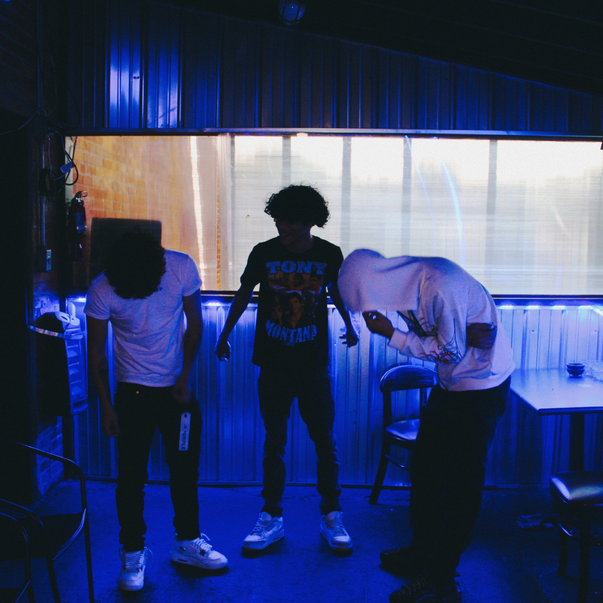 HAKYHM with friends backstage under blue lighting