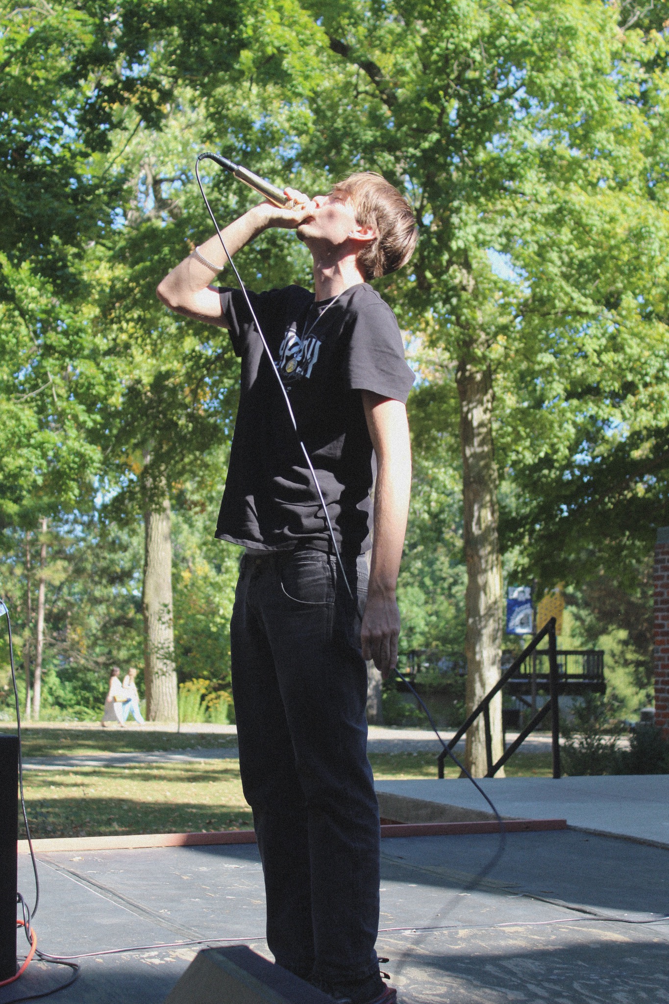 HAKYHM performing outdoors with a microphone